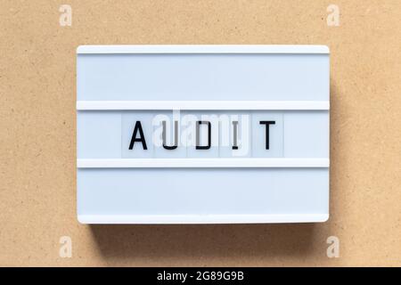 White lightbox with word audit on wood background Stock Photo