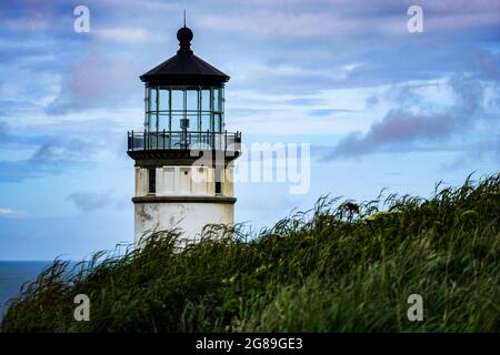 Beautiful old lighthouse, grass, Pacific Ocean and sky, coast of Washington State, USA, Pacific Northwest. Stock Photo