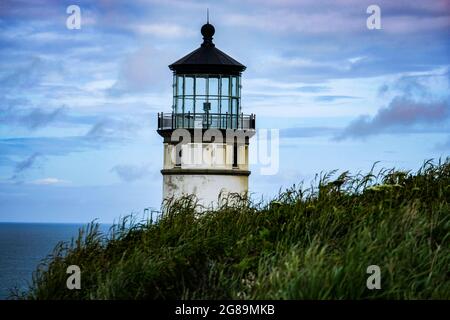 Beautiful old lighthouse, grass, Pacific Ocean and sky, coast of Washington State, USA, Pacific Northwest. Stock Photo