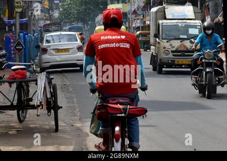 Kolkata, India. 17th July, 2021. A delivery worker of Zomato, an Indian food-delivery start-up, rides his bicycle along a road in Kolkata, (Photo by Sudipta Das/Pacific Press/Sipa USA) Credit: Sipa USA/Alamy Live News Stock Photo