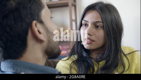 A young Indian couple having a serious conversation about their relationship at home Stock Photo