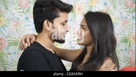 A young and happy Indian couple kissing each other on a sunny day Stock ...