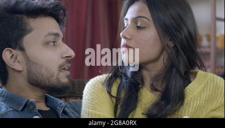 A young Indian couple having a serious conversation about their relationship at home Stock Photo