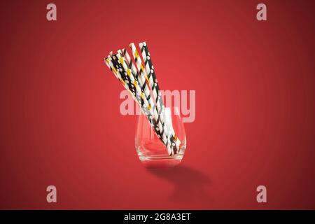 the eco bamboo color straws for the cocktail drinks on the holiday partyon color background Stock Photo