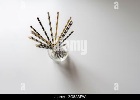 the eco bamboo color straws for the cocktail drinks on the holiday partyon color background Stock Photo