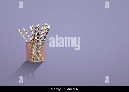 the eco bamboo color straws for the cocktail drinks on the holiday partyon color background Stock Photo