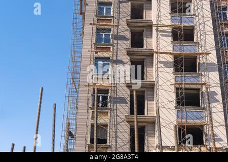 Finishing works on the facade of a new residential buildings Stock Photo