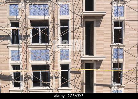 Finishing works on the facade of a new residential buildings Stock Photo