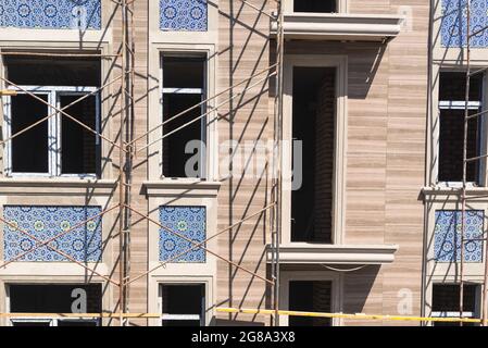 Finishing works on the facade of a new residential buildings Stock Photo