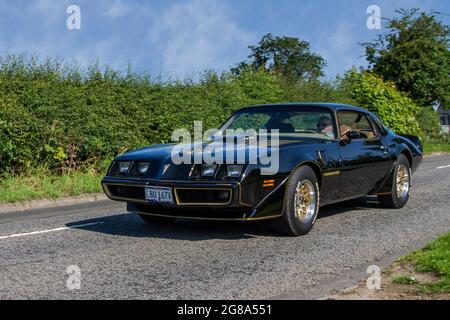 1980 80s black Pontiac Trans Am 2dr, 4900cc american coupe en-route to Capesthorne Hall classic July car show, Cheshire, UK Stock Photo