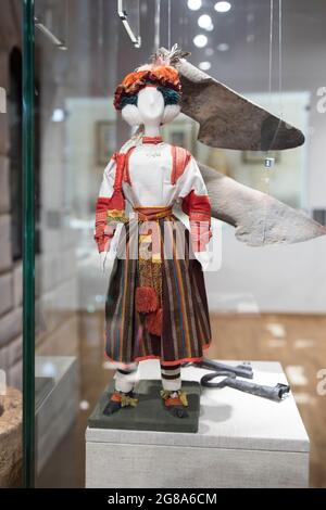 BOGORODITSK, TULA OBLAST, RUSSIA - JUNE 25 2021. The count Bobrinsky palace in Bogoroditsk city. A rag doll dressed in a Russian folk costume. Museum Stock Photo