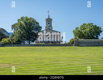 Lawn and hill of the Tennessee state capitol building in Nashville with the business district Stock Photo