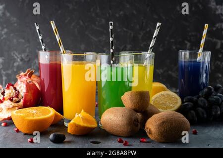 a set of cool fresh squeezed juices or cocktails in a glasses made from orange, kiwi, lemon, grapes, pomegranate Stock Photo