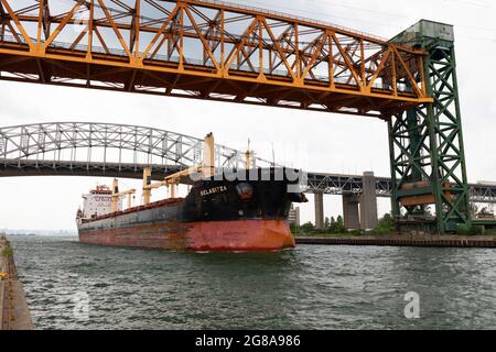 Freight ship passing under Burlington Canal Lift Bridge and Burlington Bay James N. Allan Skyway. Burlington Ontario Canada. Stock Photo