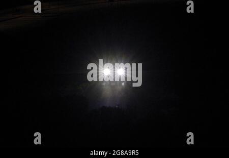 Car headlights in the night Stock Photo