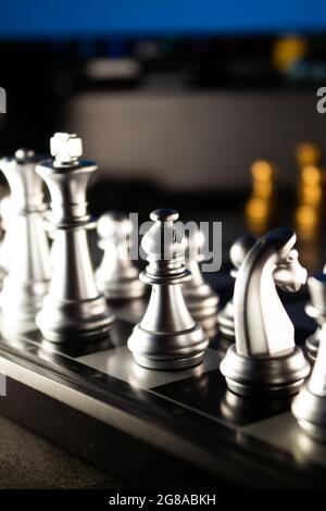 Horizontal shot of cool silver chess pieces in the starting position  reflected on the board Stock Photo by wirestock