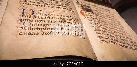 TURIN, ITALY - CIRCA MAY 2021: antique Medieval manuscript with ancient calligraphy. Stock Photo