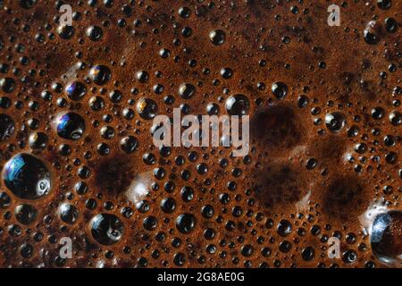 Closeup of coffee foam background. Macro texture of brown coffee foam. Stock Photo