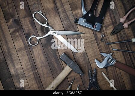 Different old tools on vintage wooden background. Flat lay. Stock Photo