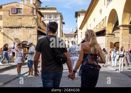 Couple with protective masks in streets of Italy. People, tourists wearing face masks during covid 19 quarantine in Italy. Slow reopening Stock Photo
