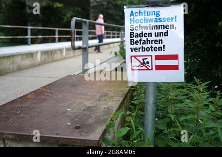 Signpost on bridge over river Limmat in Switzerland. It is in German language and it says beware of high water. No bathing, swimming and trespassing. Stock Photo