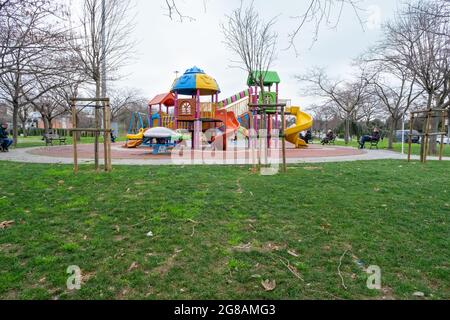 Bayrampasa, Istanbul, Turkey - 02.17.2021: Topkapi public park with slides and playground in a cloudy day and no kids with copy space Stock Photo
