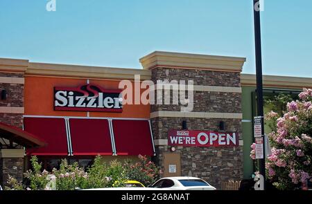 Sizzler Restaurant we're open sign in Manteca, California Stock Photo