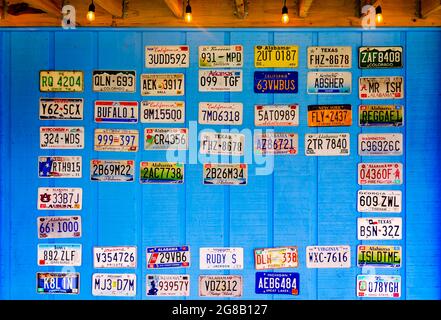 License plates hang on the wall outside Foxy’s Waffle Bar and Sugar Den, July 7, 2021, in Dauphin Island, Alabama. Stock Photo