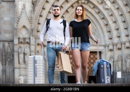 Pretty man and woman going the historic city center Stock Photo