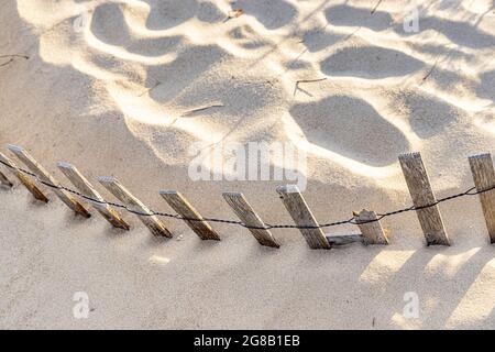 detail image of beach fencing in sand Stock Photo