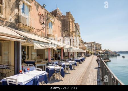 Cozy waterfront cafes and restaurants in Siracusa old town Ortygia, Sicily, Italy Stock Photo