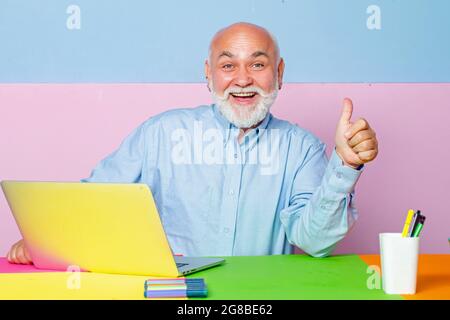 Happy Senior man employees consulting with laptop in office. Old businessmen using notebook at meeting. Stock Photo