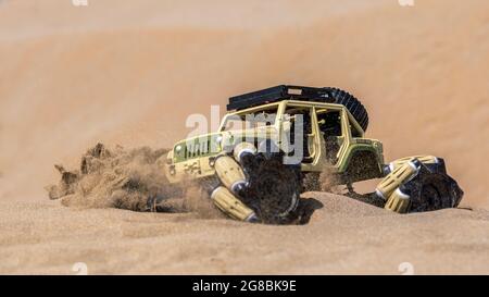 Radio controlled buggy car with electric engine on sand. Off road rally Stock Photo