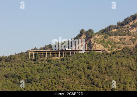 Abandoned, non-functioning cement factory that extracted ore from the mountain. Stock Photo