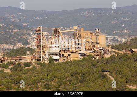 Abandoned, non-functioning cement factory that extracted ore from the mountain. Stock Photo