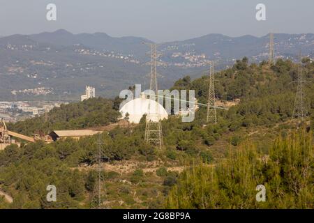 Abandoned, non-functioning cement factory that extracted ore from the mountain. Stock Photo