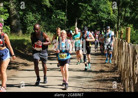 a mixed group of black and white, male and female, runners in a race Stock Photo