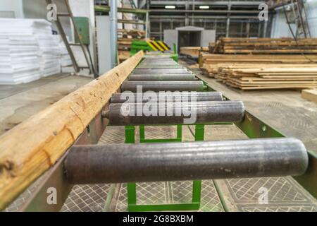 Conveyor line or belt in woodworking workshop for production of wooden products. Stock Photo