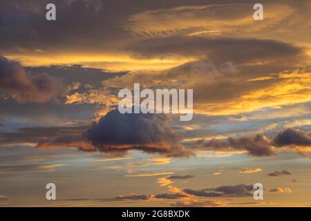 orange golden and warm gray clouds at sunset abstract background Stock Photo
