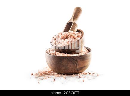 Himalayan pink salt in wooden bowl isolated on white background. Stock Photo