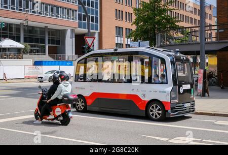 Hamburg, Germany - Autonomously driving elevated electric bus and an Emmy electric scooter in Hamburg's Hafencity. Stock Photo