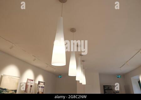 Included chandeliers on the ceiling close-up. Light and interior design. Office lamps Stock Photo