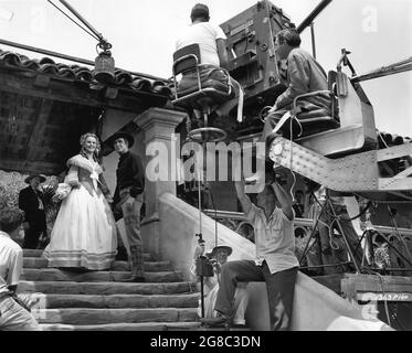 DEANNA DURBIN and ROBERT PAIGE on set candid with Movie Crew with Technicolor Camera on Crane during filming of CAN'T HELP SINGING 1944 director FRANK RYAN producer Felix Jackson Universal Pictures Stock Photo