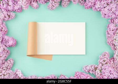 Open notepad with lilac flowers Stock Photo