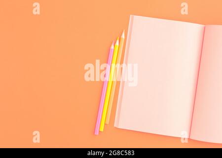 Pink notebook with colored pencils. Stock Photo