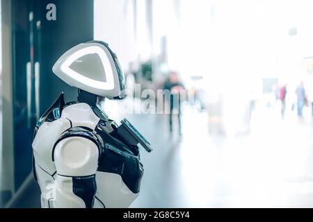 Technological progress of smart robot assistant with artificial intelligence in public place. Futuristic concept of robotics, machines in daily life Stock Photo