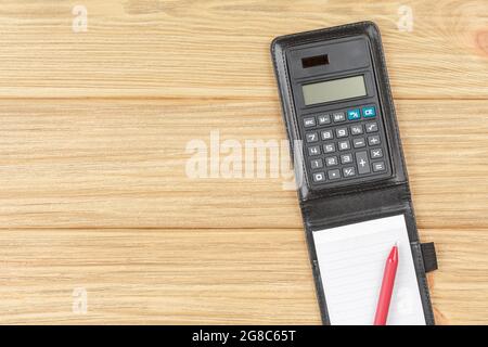 Calculator with notebook in black leather bound. Stock Photo