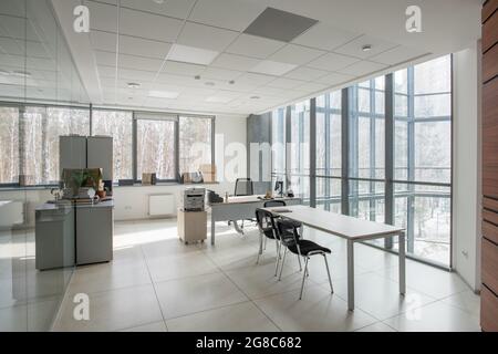 Image of empty modern office with chairs and desks in office building Stock Photo