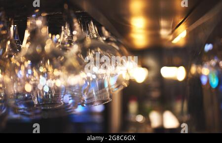 details of wine or beer glasses hanging on a restaurant bar Stock Photo