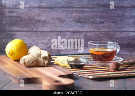 green tea with ginger, lemon and honey on wooden background. Stock Photo